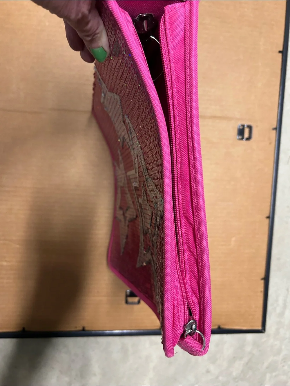 Hot pink, 3 ring binder notebook that zips up and has sequins on the front.